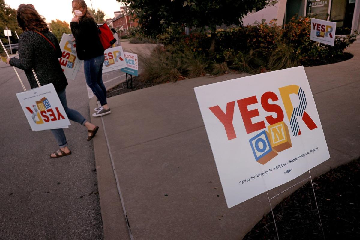 Supporters for the Yes on R ballot measure carry out promotional yard signs as they leave the campaign kickoff on Thursday, Oct. 1, 2020, at Flance Early Learning Center in St. Louis. Proposition R, which would raise property taxes by 6 cents/$100 valuation for early childhood programs is a product by the Ready by Five Campaign. A similar campaign failed to make it to the ballot in St. Louis County. Photo by Christian Gooden,